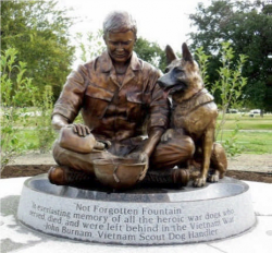 Image of the Not Forgotten Fountain at the Military Working Dog Teams National Monument. The bronze sculpture is a water fountain that represents a Vietnam-era dog handler and his German Shepherd.