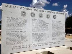 Image of the back wall of the Military Working Dog Teams Monument. The monument honors the history and sacrifices made by military working dogs and their handlers. 