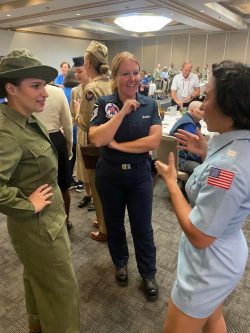 Volunteers in uniform speak with Thunderbirds Sq. member.