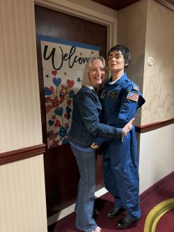 WAF Veteran Sherry Chadwick doing the "hokey-pokey" with a Flight Nurse attired in a "Smurf Suit".